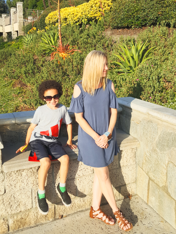 Shari and her son beside a sunlit garden